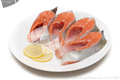 Image of Red fish bit with lemon on plate