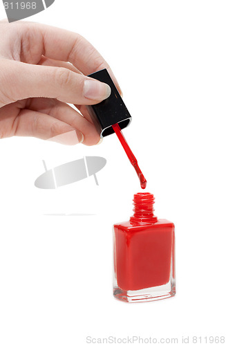 Image of Hand with tassel and red varnish for nail
