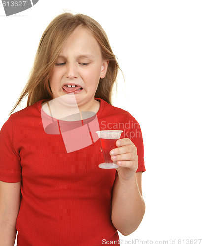 Image of young girl taking medicine