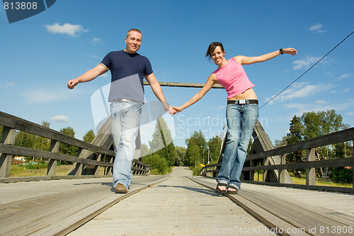 Image of Couple having fun on bridge