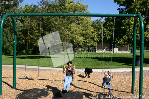 Image of Mother and Little Boy Swinging