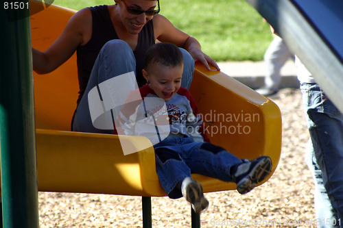 Image of Little Boy Sliding with his Mother