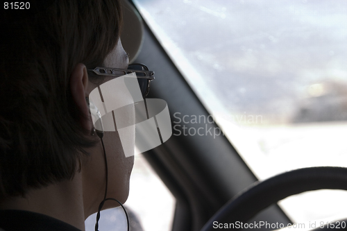 Image of Close up on a woman driving with a headset on