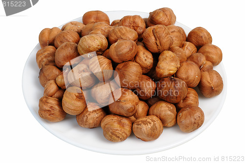 Image of Hazelnuts on a white plate, isolated.