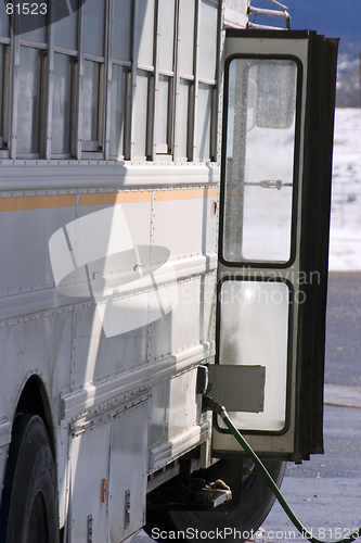 Image of White School Bus Pumping Gas