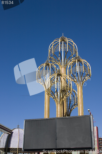 Image of Four Metal Umbrellas with a Blank Billboard in front of it