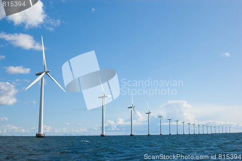 Image of Windmills in a row on sunny weather, front