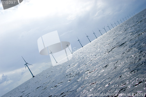 Image of Diagonal shot of windmill turbines in a row