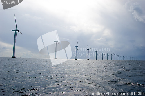 Image of Windmills in a row on cloudy weather