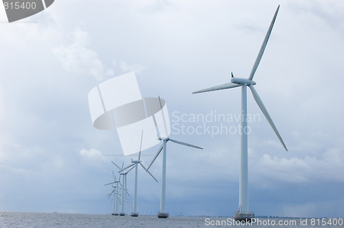 Image of Windmills on cloudy weather,  back shot