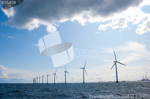 Image of Windmills in a row on sunny weather,  back shot