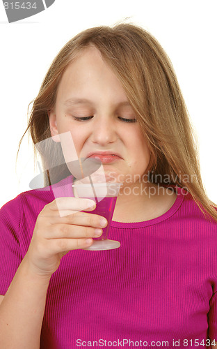 Image of young girl taking medicine