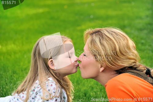 Image of Mother is kissing her daughter