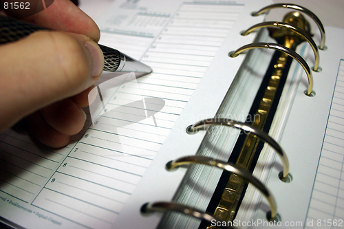 Image of Hand writing in daily planner