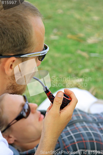 Image of Boy,  girl and smoking pipe.