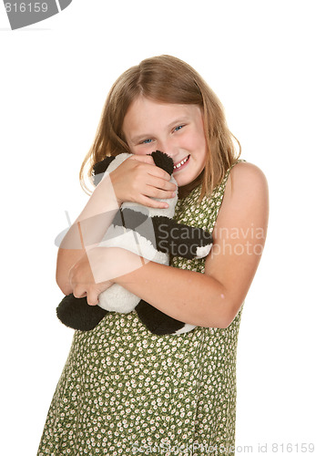 Image of girl hugging her teddy bear