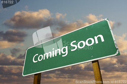 Image of Coming Soon Green Road Sign Over Clouds