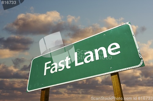 Image of Fast Lane Green Road Sign Over Clouds