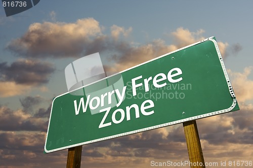 Image of Worry Free Zone Green Road Sign and Clouds