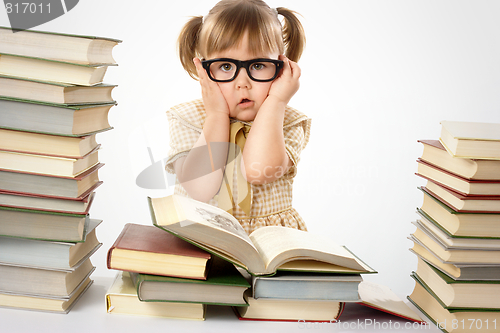 Image of Little girl with books wearing black glasses