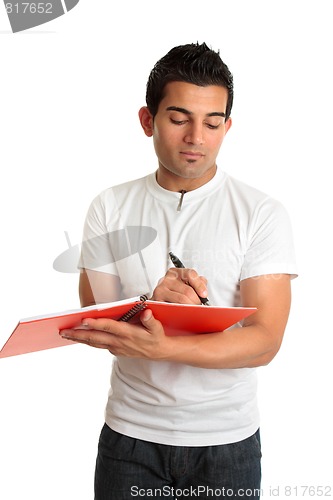 Image of Man or student writing in a notebook