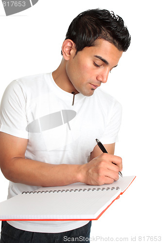 Image of Man or student writes in a notebook