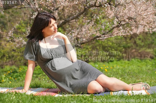 Image of pregnant woman by springtime