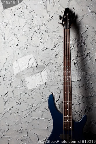 Image of guitar near wall