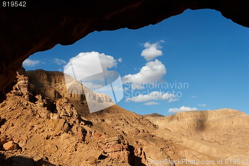Image of Rocky desert landscape through the cave entrance 
