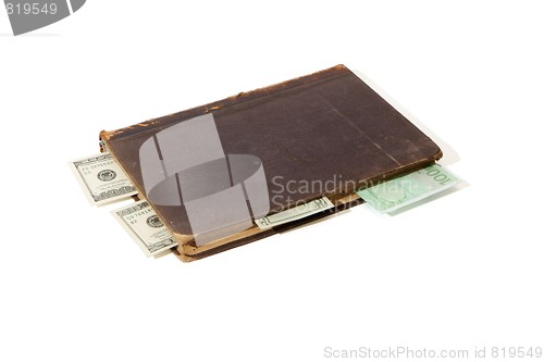 Image of Old book with banknote bookmarks isolated 