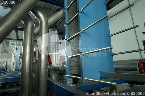 Image of Pipes, tubes, machinery and steam turbine at a power plant