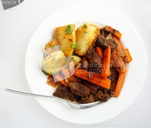 Image of Plate of beef and carrot stew from above