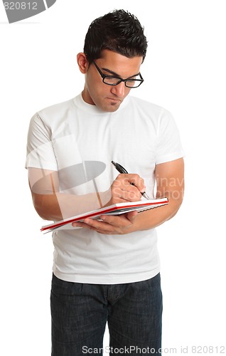 Image of Man writing in a book notepad