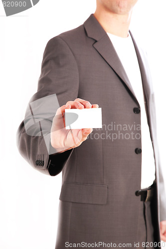 Image of A business man holding his unmarked business card into the camer