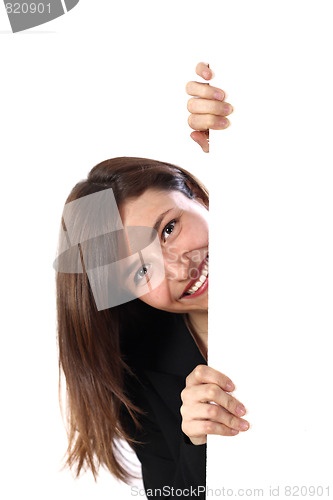 Image of Cheerful woman looks out from behind an unmarked plate. 