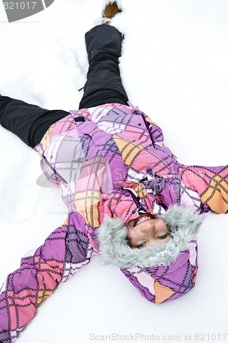 Image of Girl making snow angel