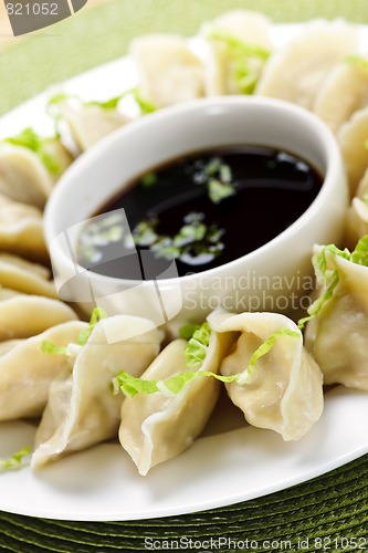 Image of Steamed dumplings and soy sauce