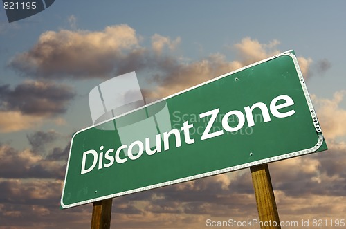 Image of Discount Zone Green Road Sign and Clouds