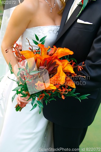 Image of Colorful Bouquet Held by a Bride and Groom