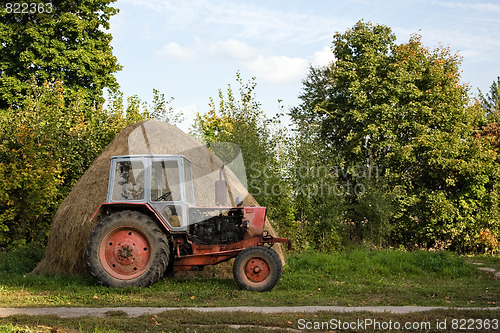 Image of Old tractor and haystack