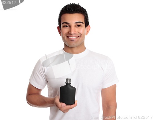 Image of Man holding black bottle or product