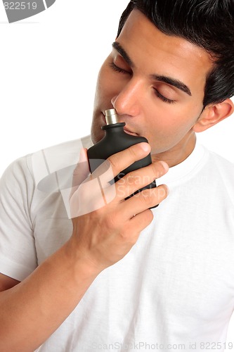 Image of Man smelling aftershave cologne