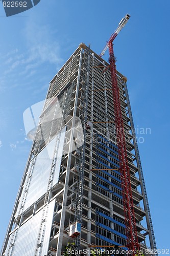 Image of Lifting crane at skyscraper construction site