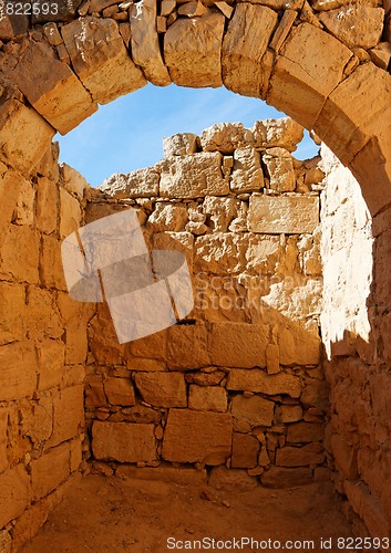 Image of Ancient stone arch and wall at castle ruin