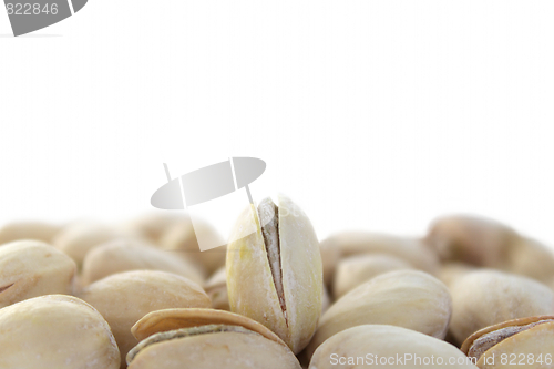 Image of Single standing pistachio among lying ones