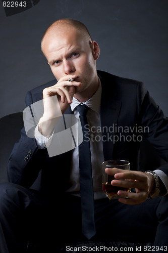 Image of blue eyed businessman siting on a sofa