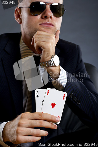 Image of businessman holding a poker hand