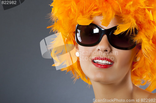Image of woman wearing  feather wig
