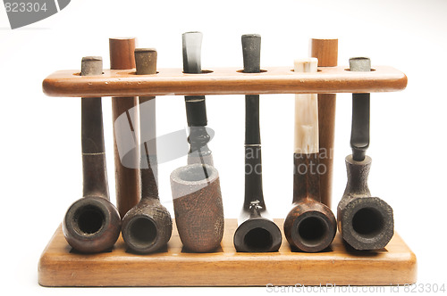Image of pipe collection in wood pipe rack