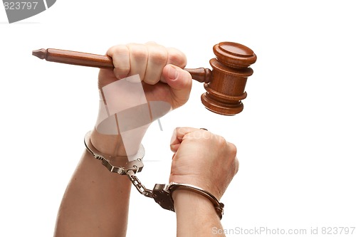 Image of Handcuffed Man Holding Wooden Gavel on White